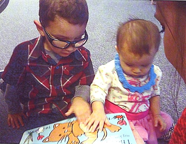 Blind children touching tactile learning props